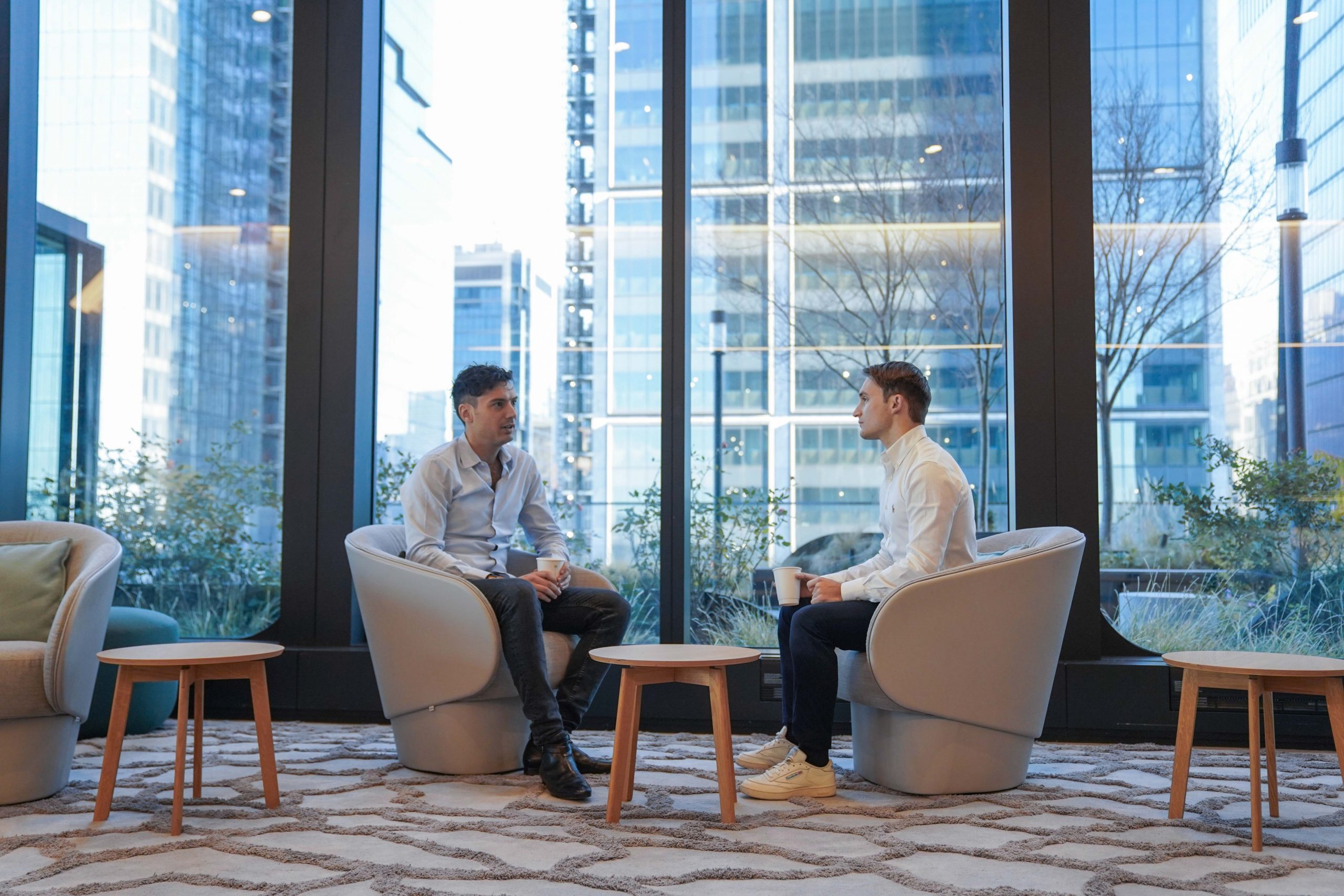 Two people sitting and talking in Schroders (SDR.L)'s Hudson Yards office