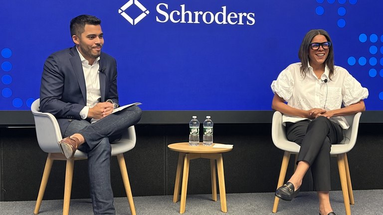 Man and woman speaking on panel